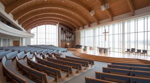 Interior of prefabricated steel church building with spacious sanctuary and acoustic design.