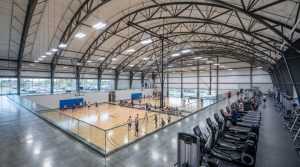 spacious indoor facility with basketball courts and cardio equipment
