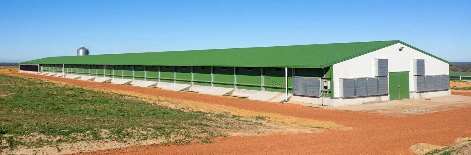 Long green-roof chicken house with side openings and service access in Australia