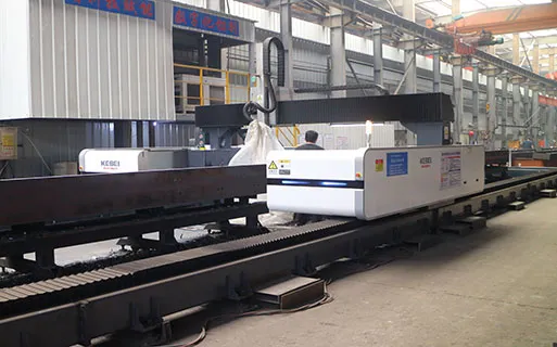 CNC cutting equipment processing steel beams for customized prefabricated steel structure building projects with accurate factory fabrication control.
