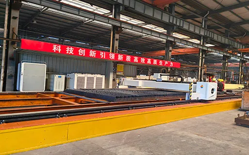 CNC processing line fabricating steel plates and components for prefabricated steel structure building projects with controlled factory production.