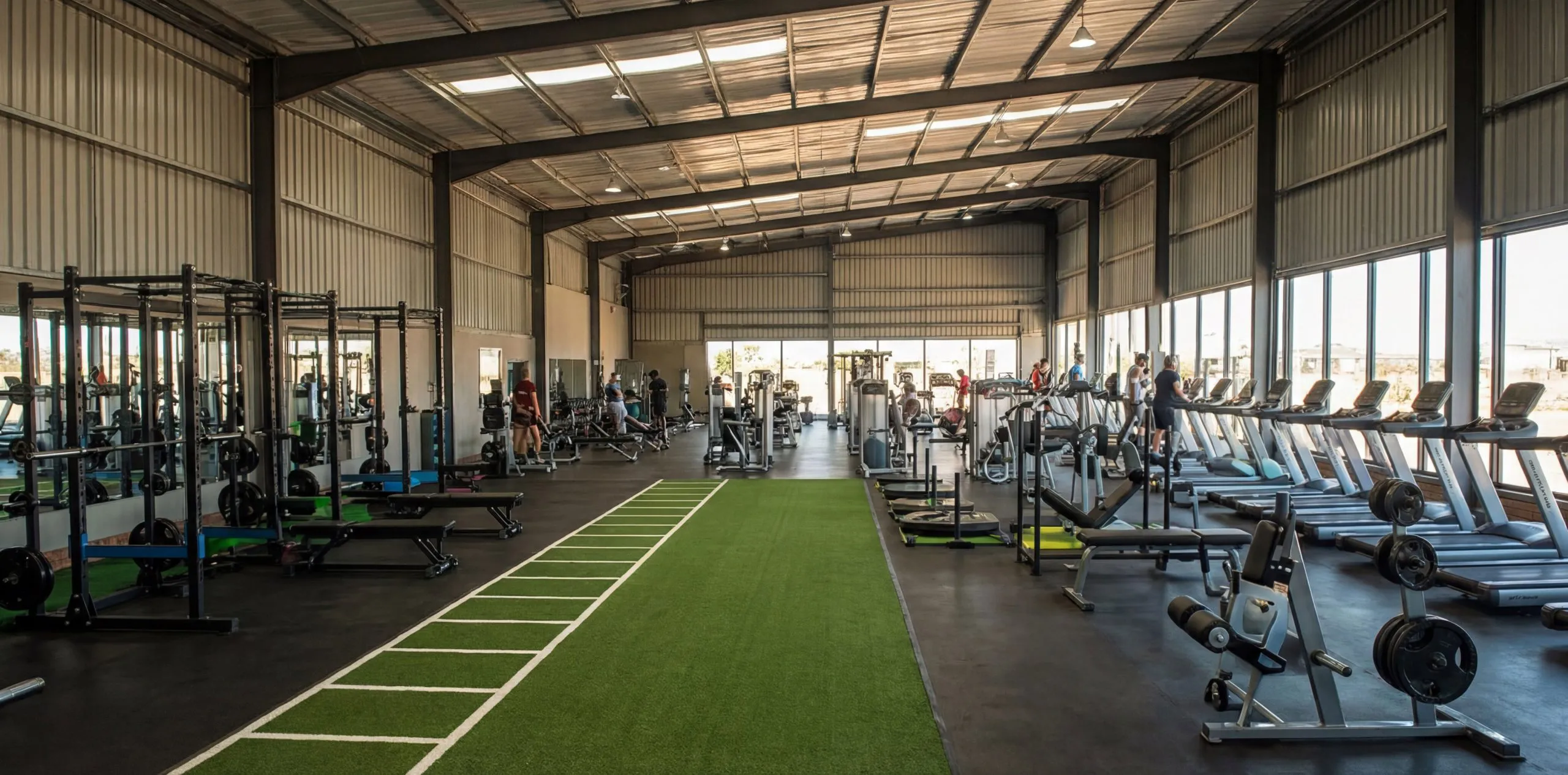 Commercial gym interior design featuring large span steel structure, fitness zones and open training space.