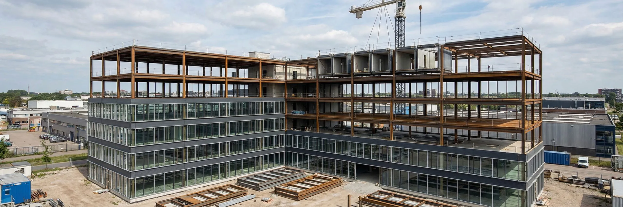 Upper steel framing above enclosed lower floors illustrates future vertical expansion planning for a multi-storey building.