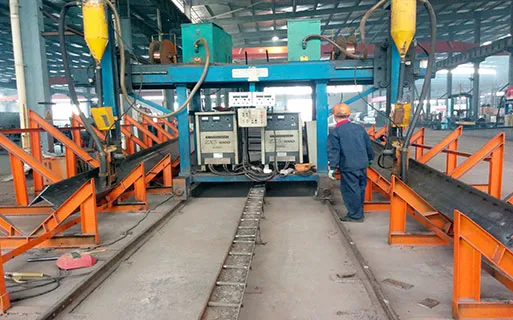 Automatic H beam welding line for steel structure building production, supporting accurate fabrication of steel columns and beams for prefabricated projects.