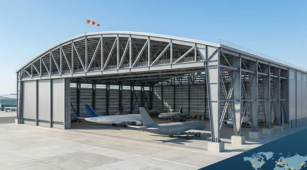 Large aircraft hangar with a curved steel truss roof, wide open entrance, windsock, and multiple commercial jets inside.