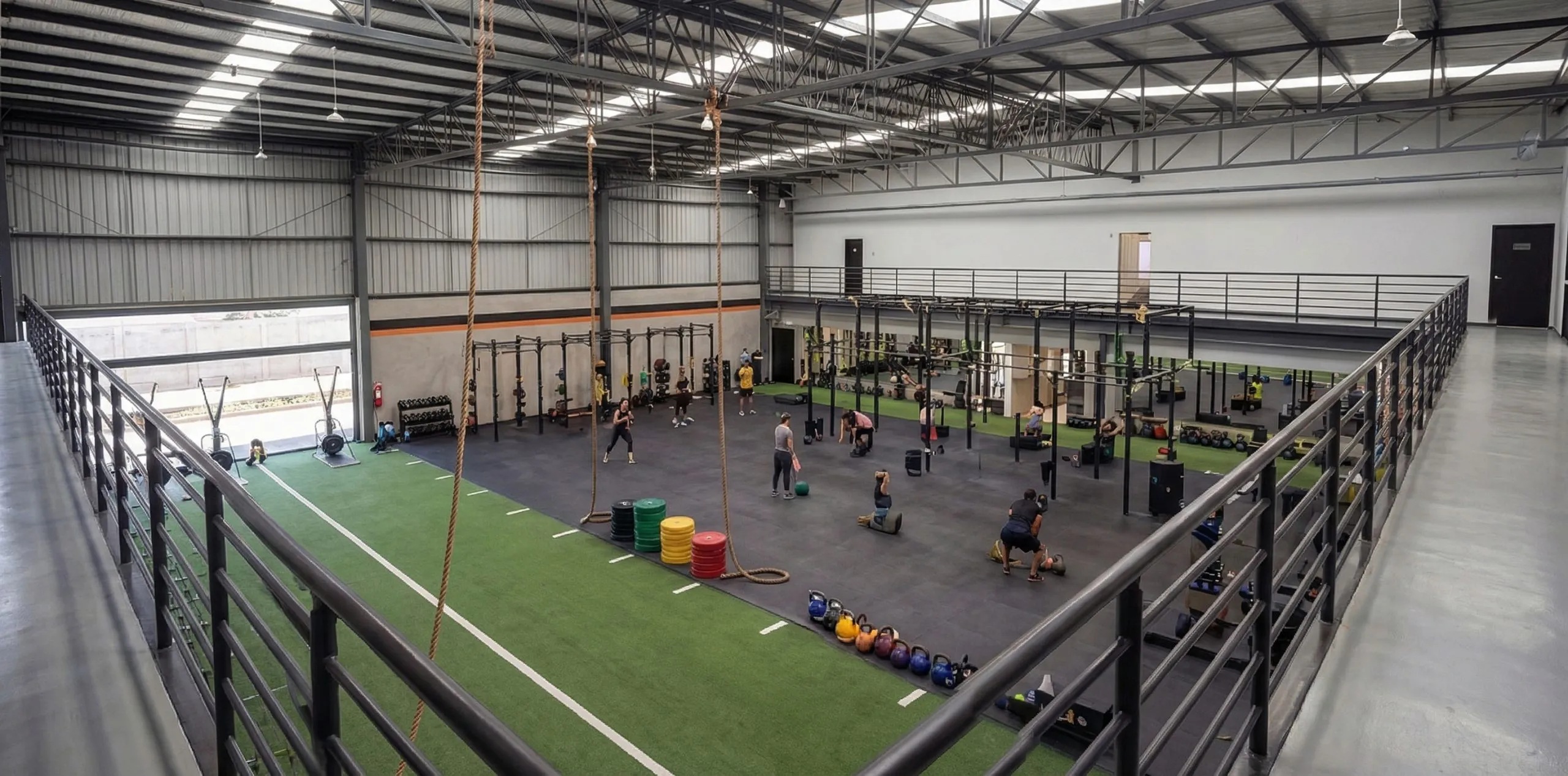 Mezzanine gym design featuring steel frame interior, open training areas and multi-level fitness space.