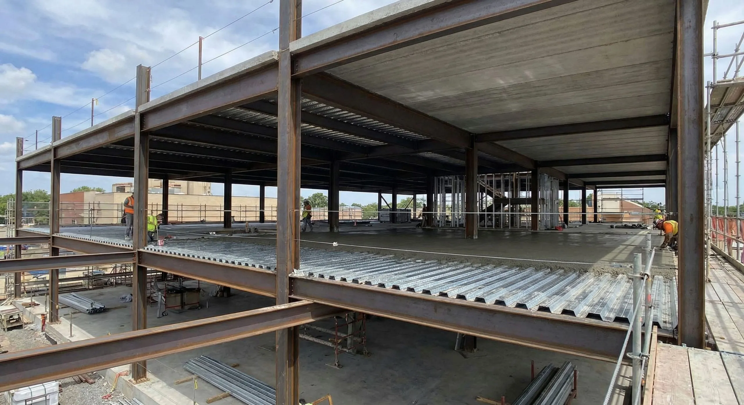 Composite floor construction in a multi-storey steel structure building, with concrete placed over profiled steel decking and beams.