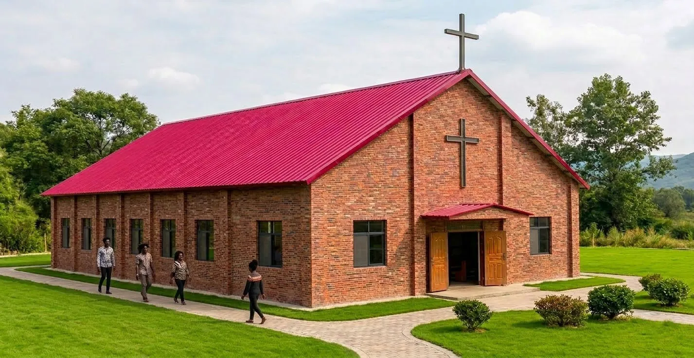 Completed brick-clad steel church with a crimson roof and crosses in Papua New Guinea.