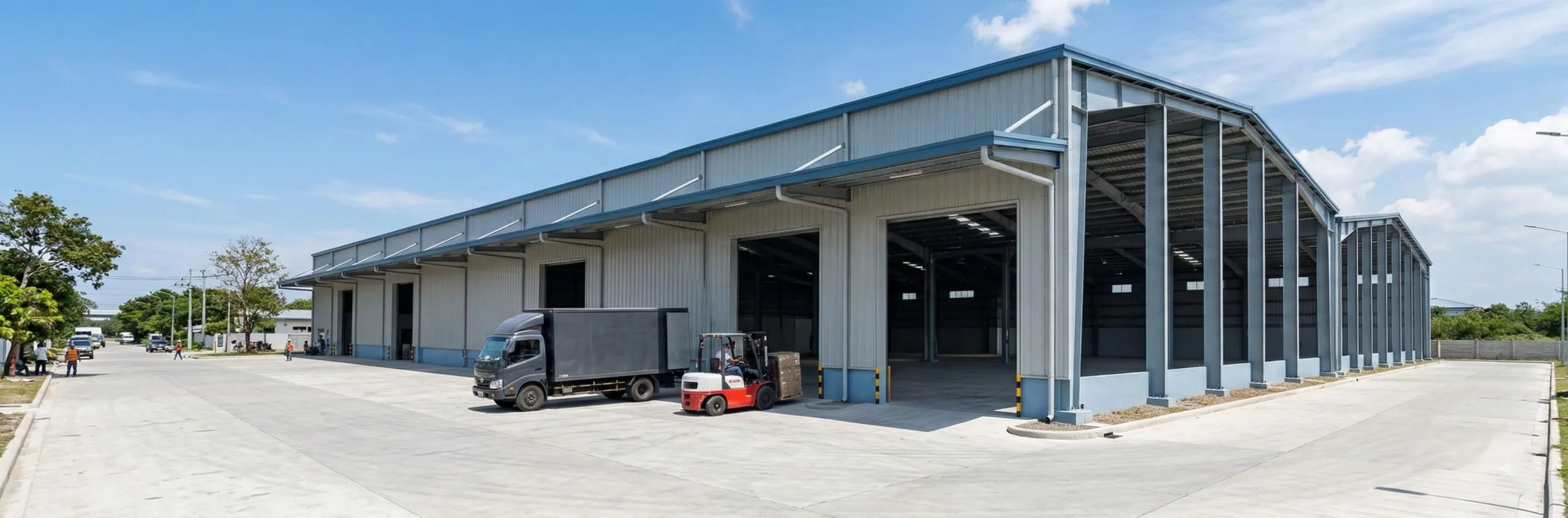 Completed logistics warehouse with loading bays, a delivery truck and forklift in the Philippines