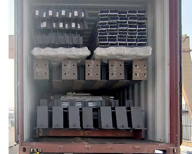 Prefabricated steel structure workshop components loaded in a shipping container with steel beams, columns, purlins, and connection plates.