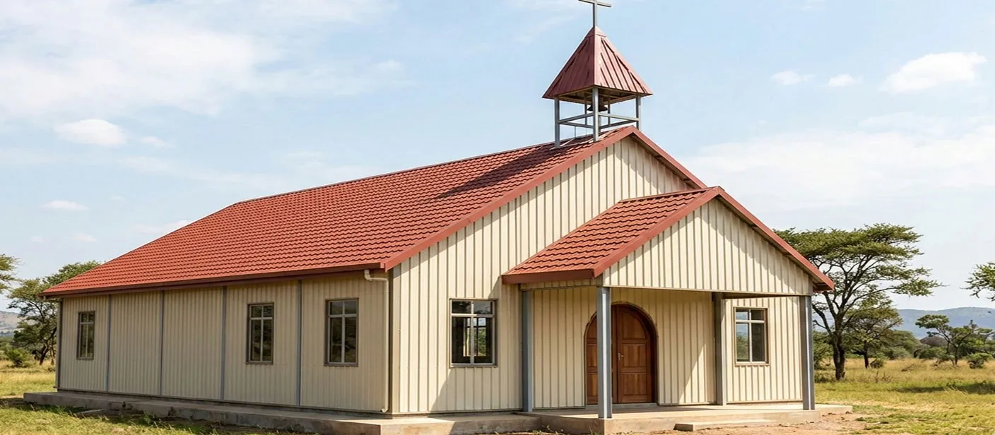 Small church building with vertical metal wall panels, red pitched roof, front entrance canopy, and cross-topped tower for rural worship projects.