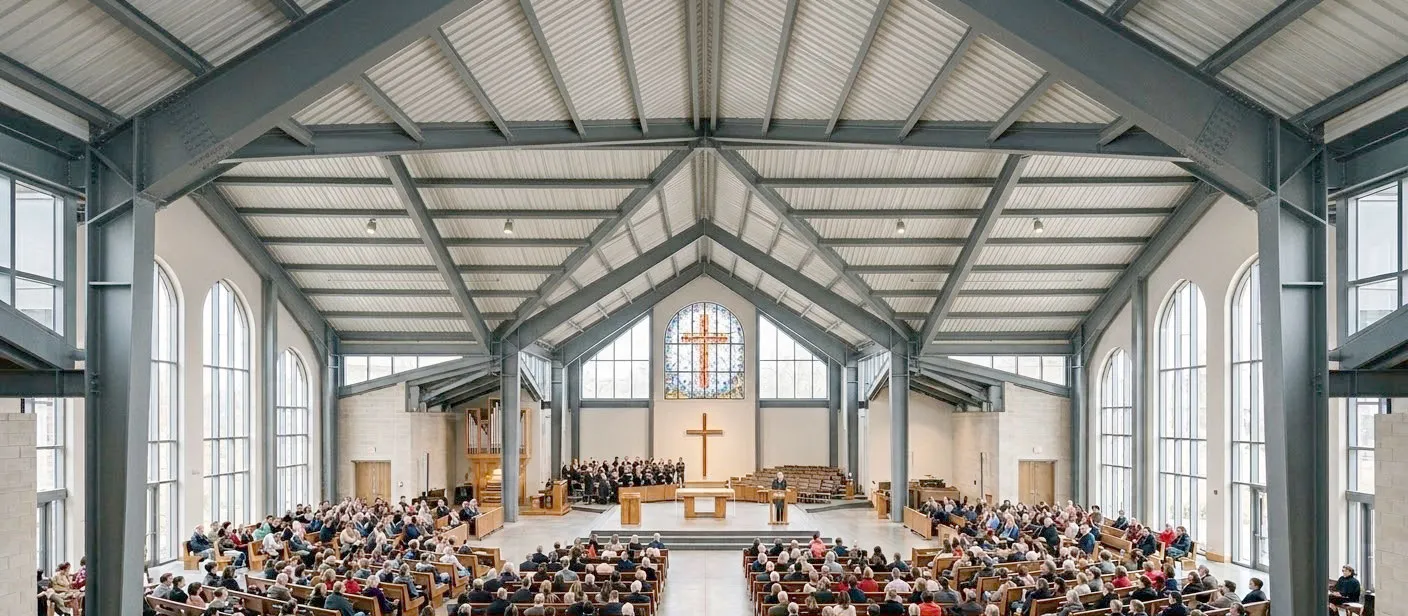 Church building interior design showing a clear-span worship hall, exposed steel frame, arched windows, pew seating, and central cross for worship services.