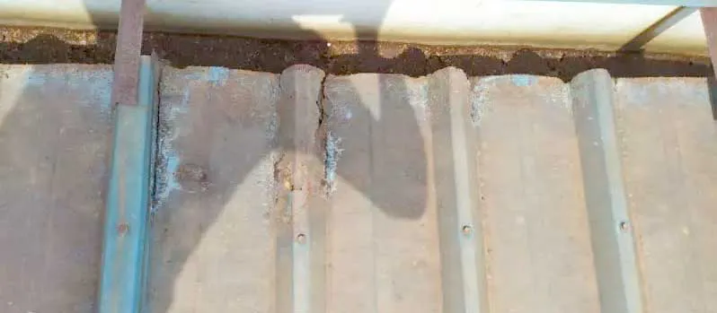Steel structure workshop roof panel detail showing metal cladding edges, fastener points, and local maintenance condition.