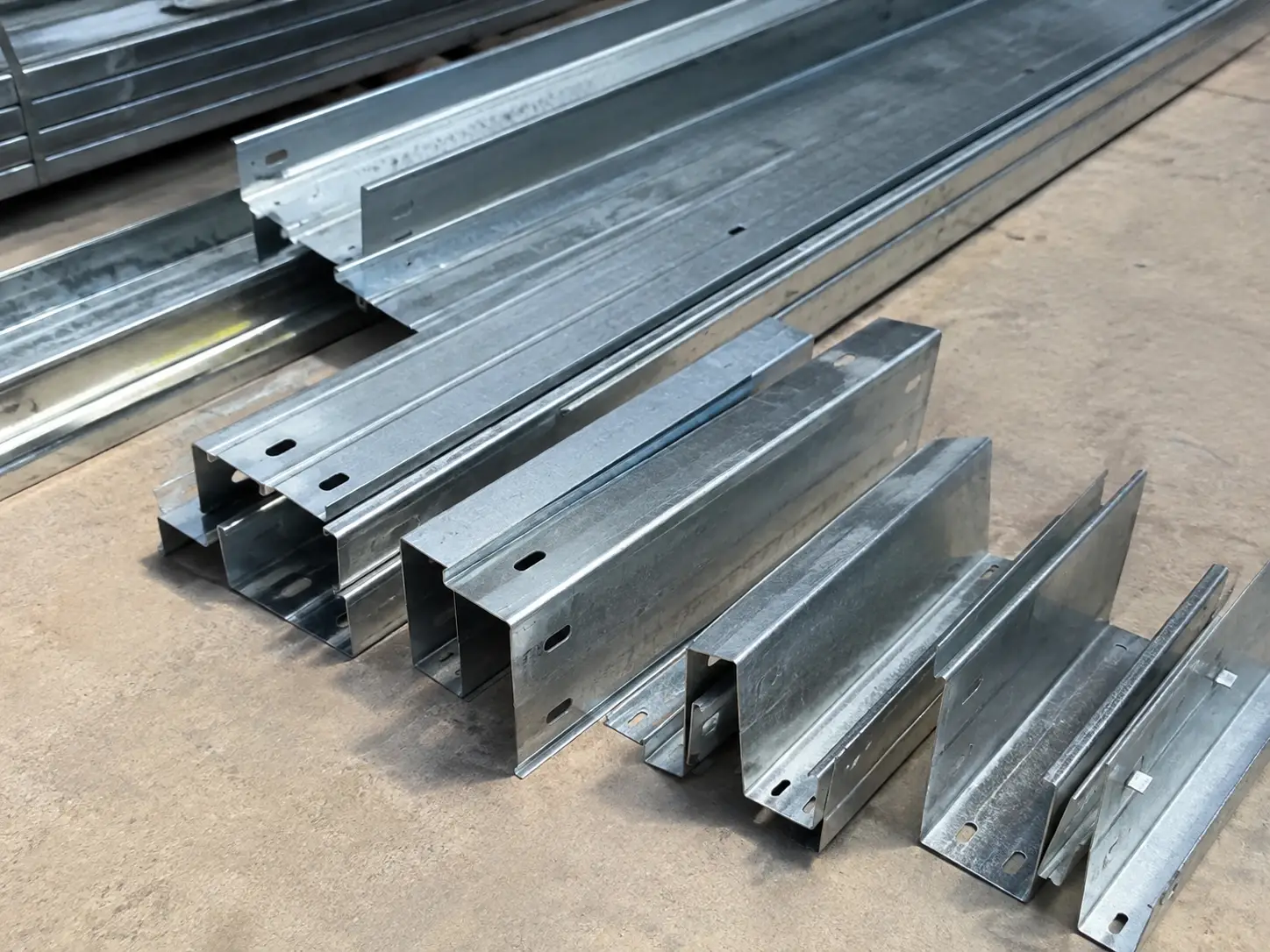 Roof and wall purlin components for steel structure warehouse with galvanized C and Z sections prepared for installation