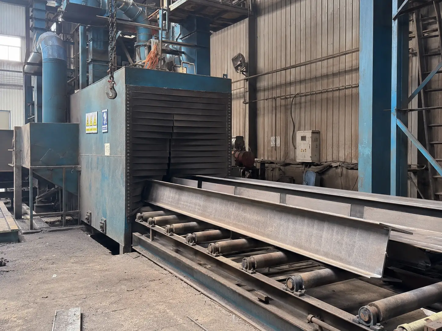 Steel beam sandblasting process in fabrication factory for surface preparation before painting