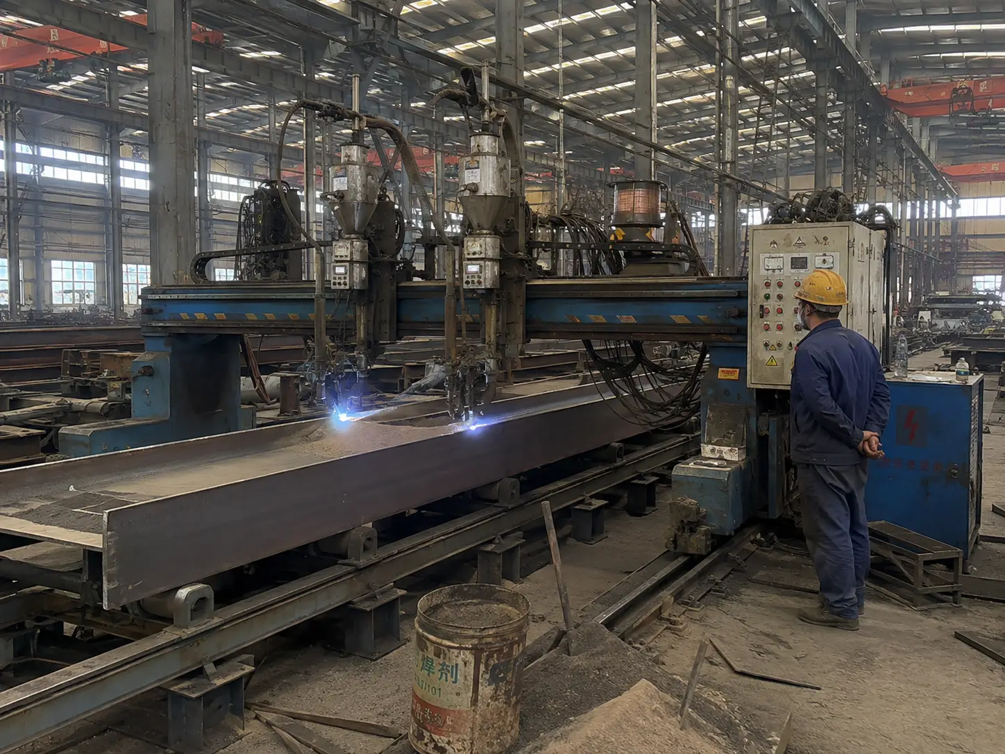 Submerged arc welding machine welding steel beams in fabrication factory production line