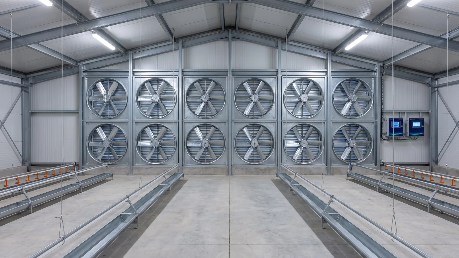 Chicken House End-Gable Exhaust Fans Rows of exhaust fans installed on the end gable of an enclosed steel chicken house.