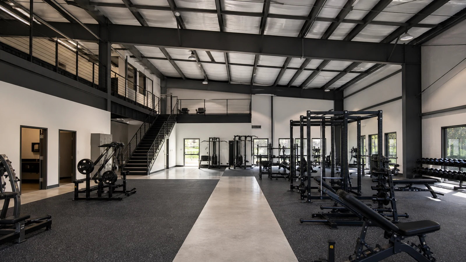 Completed steel gym interior with open circulation routes and clear-span training areas.
