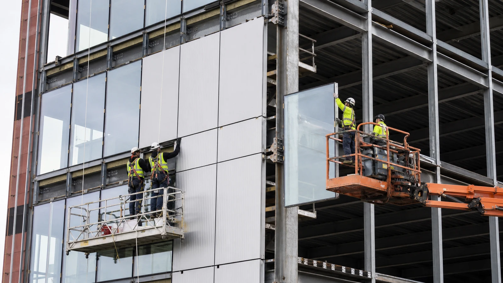 Crew installs panels and glazing on a multi-storey steel office building