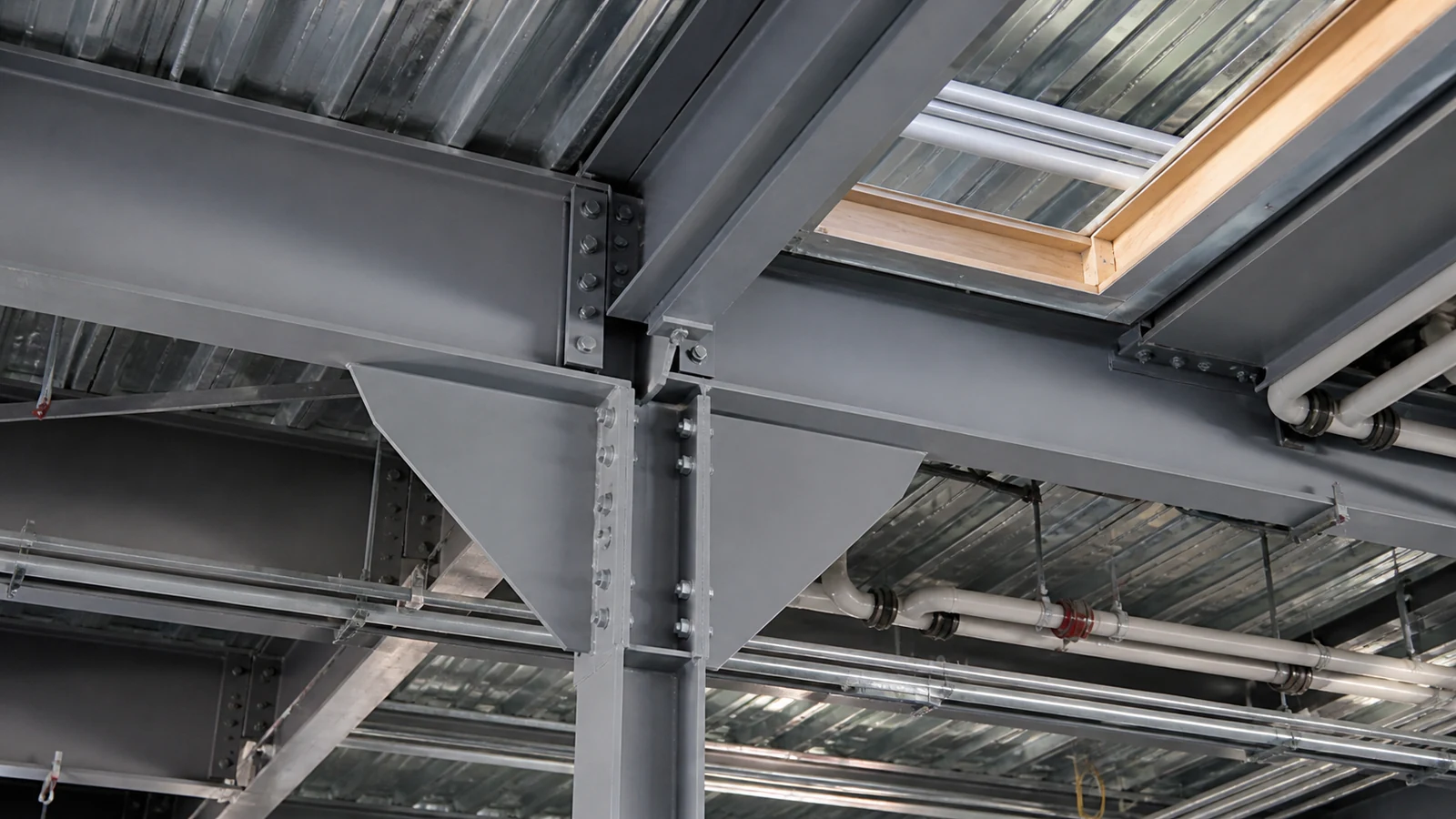 Close view of coordinated service openings and steel framing in an office floor zone.